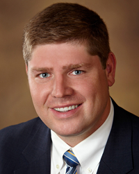 a portrait of a main in a suit and tie
